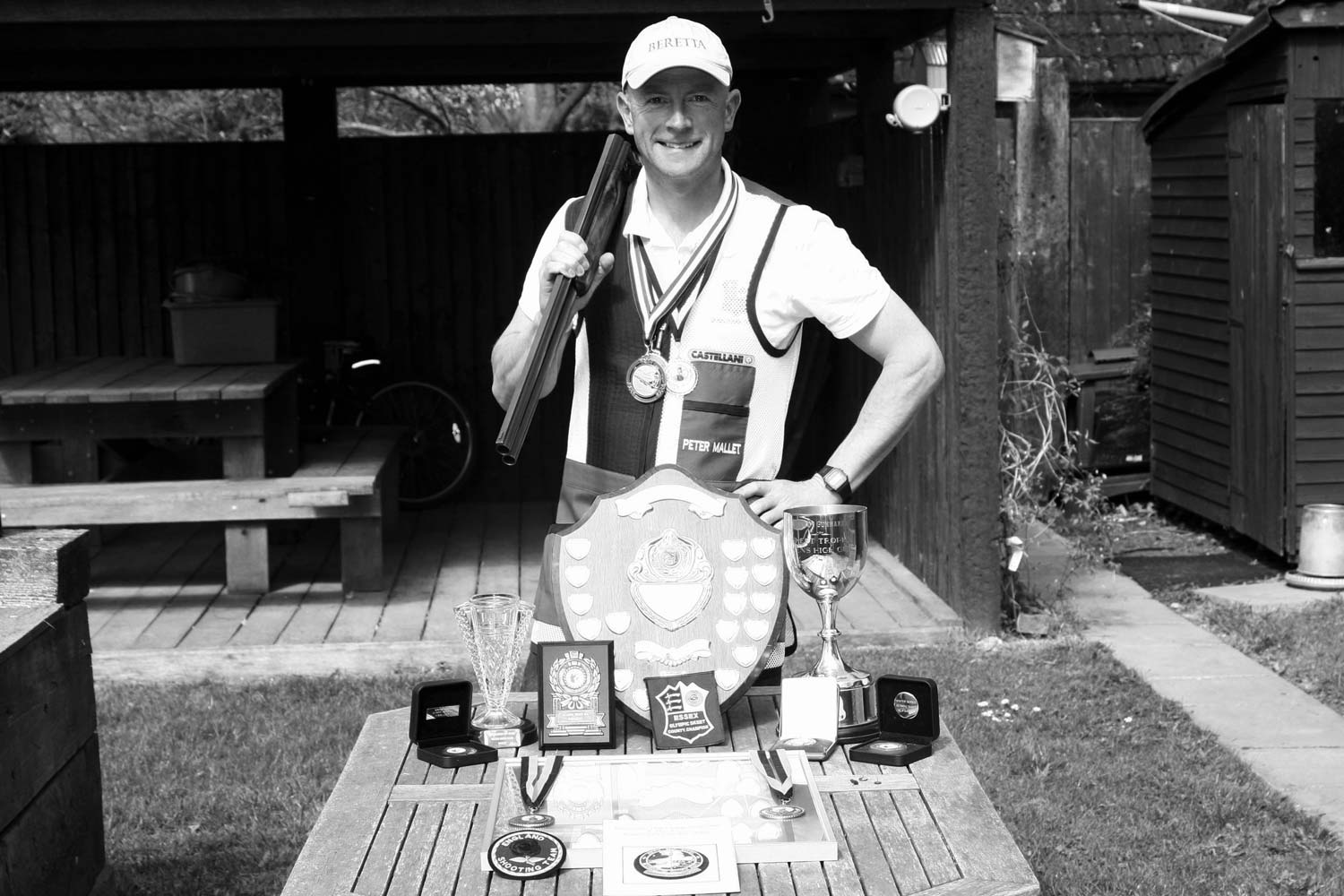 Pete in his Olympic Skeet Shooting Gear with all his shooting trophies